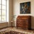 Rosewood and mahogany drop-leaf chest with alternating maple and rosewood trim. The upper drop-leaf door conceals a...