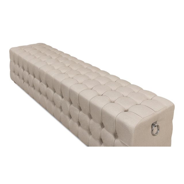 There"s tufting all around on this long bench. The ring handles on either end add another very nice touch. It will be...