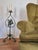 A floor candelabra in wrought iron with antique bronze finish, Swedish Grace 1920/30s. Decor in cast iron of huntress...