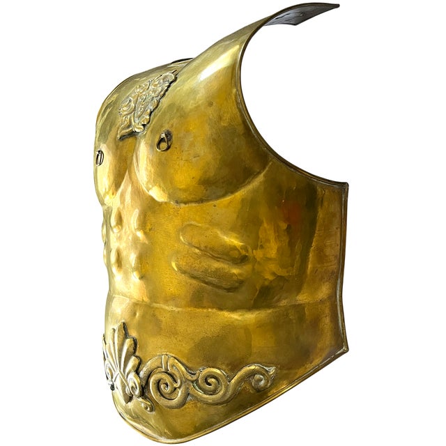 A dramatic mid-20th-century life-size brass wall sculpture inspired by the ceremonial armor of ancient Rome. Formed as a...