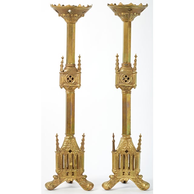 Grand gothic brass candlesticks standing 2 feet tall. The candlesticks can accommodate candles 1.25" in diameter.