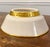 This is an elegant serving bowl from Lenox featuring a classic ivory base color adorned with a distinctive gold rim and a...