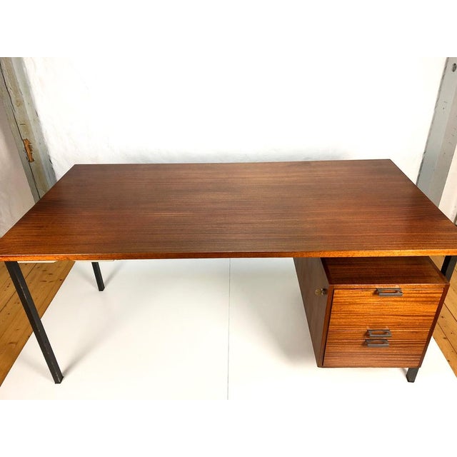 Teak desk by Herbert Hirche for Holzäpfel / Germany, 1950s, with 3 drawers and a pen pullout below the top. The wooden...