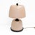 Pair of refined table lamps crafted in Murano glass in a delicate blush pink tone, featuring a smooth, luminous surface...