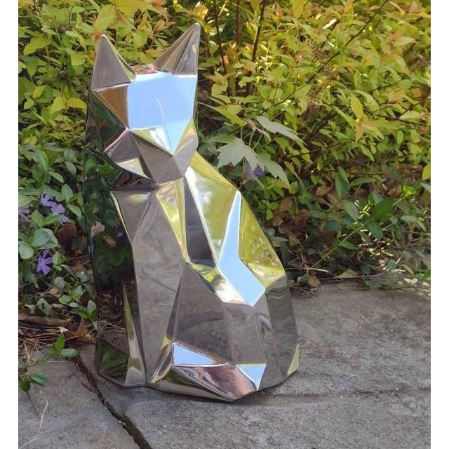 A striking life-size geometric cat sculpture handcrafted from mirror-polished stainless steel. Inspired by contemporary...