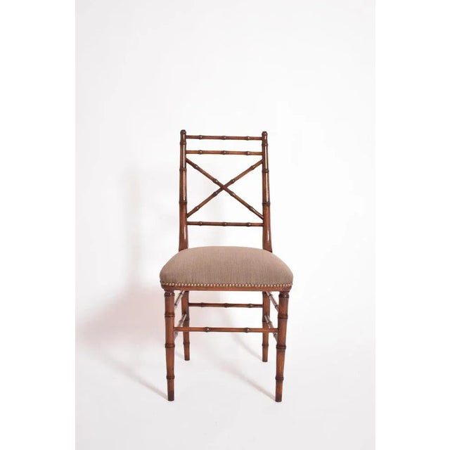 Faux bamboo chair, 1960s. Faux bamboo natural wood chair, with cross-braced back, the 4 legs connected by spacers. France,...