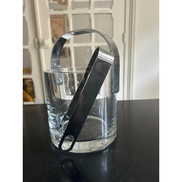 Crystal ice bucket from the 70s with its steel tongs product published by Orrefors, Sweden design Henning Koppel This...