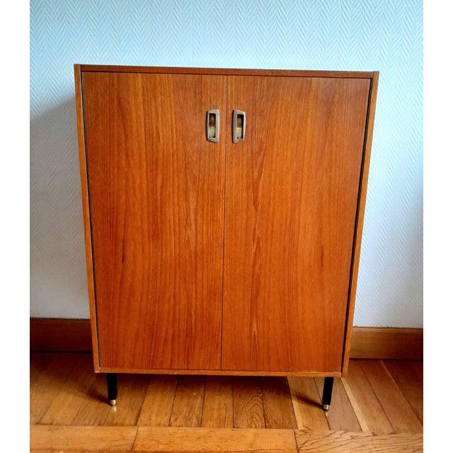 Mid-century shoe cabinet, circa 1950/1960 Cherry wood shoe cabinet with two drop-down doors opening to reveal shoe racks...