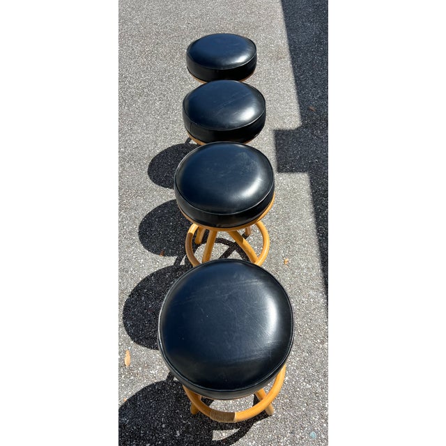 Bamboo spiral legs black barstool set of four with swivel seats featuring two single-stand stools and one with a stacked...