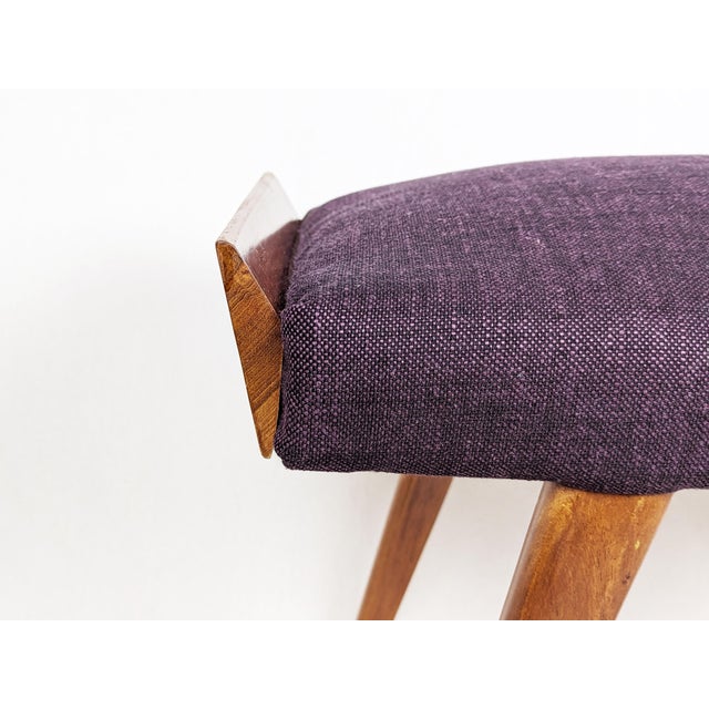 This stool features a wood frame and is reupholstered in purple fabric. Ideal as ottoman or serving stool. Very good...