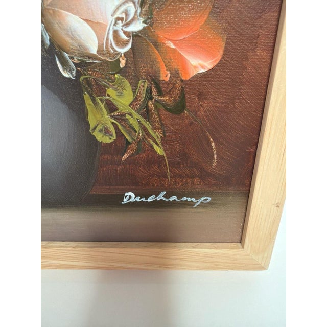 Vintage signed Duchamp floral still life oil painting featuring vibrant pink and orange roses in a dark vase. This piece...