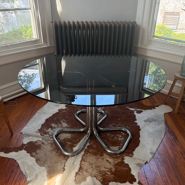 Wonderful and very rare Giotto Stoppino 70’s chrome and smoked glass dining table. A few small scratches on the glass and...
