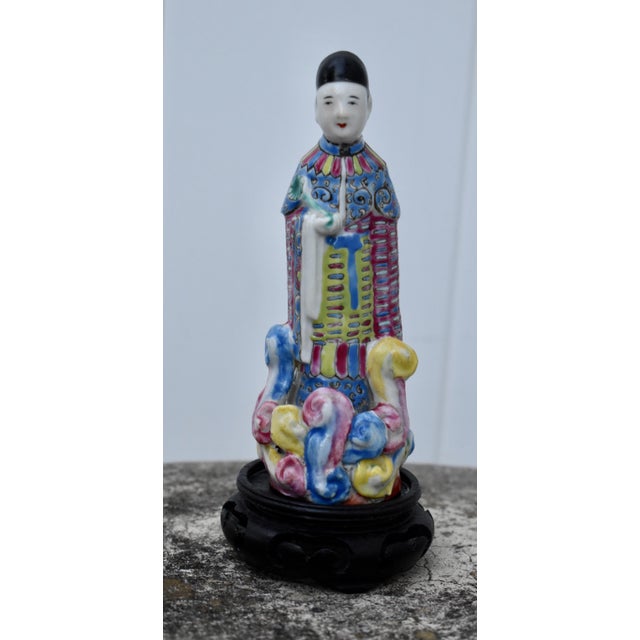 Vintage (1950's) Chinese Figure in a Multicolor Finish. Made of Ceramic with a Wooden Base. The Measurements: 2"W x 2"D x...