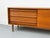 Perfectly proportioned, low teak sideboard with three drawers and a sliding door with a round recessed handle. Includes...