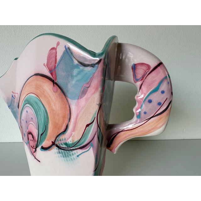 This vintage handmade and painted sculptural ceramic vase is an eye-catching and artistic piece that combines both form...