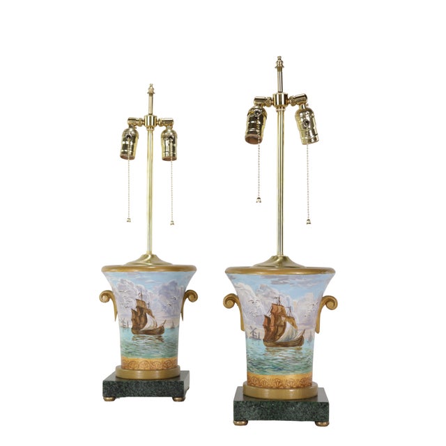 This pair of lamps features a neoclassical "campana" urn-shaped design, with a beautifully hand-painted nautical landscape...