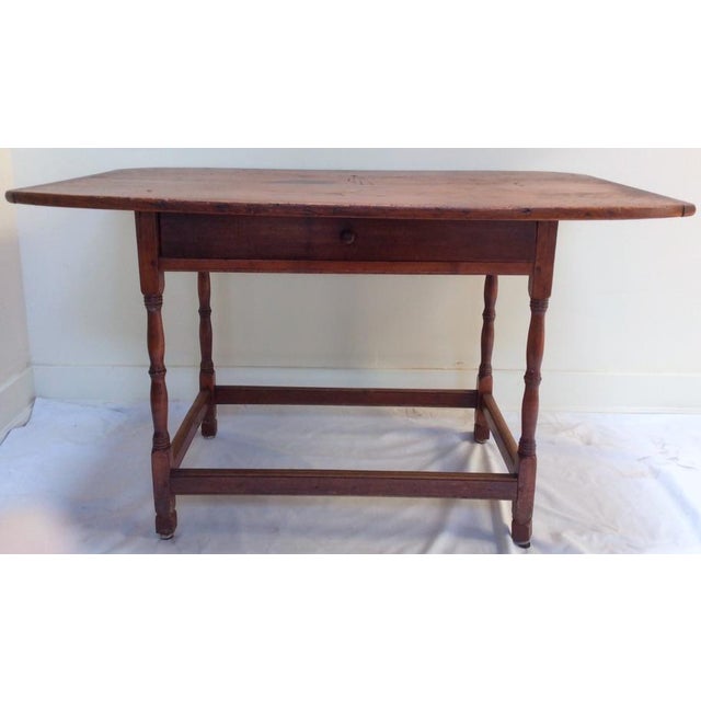 This 18th century American kitchen table has turned legs and rails between each giving the piece a lot of stability. There...