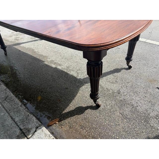 This 2 leaf 19th century English Victorian mahogany extension dining table is a stunning antique piece that exudes vintage...