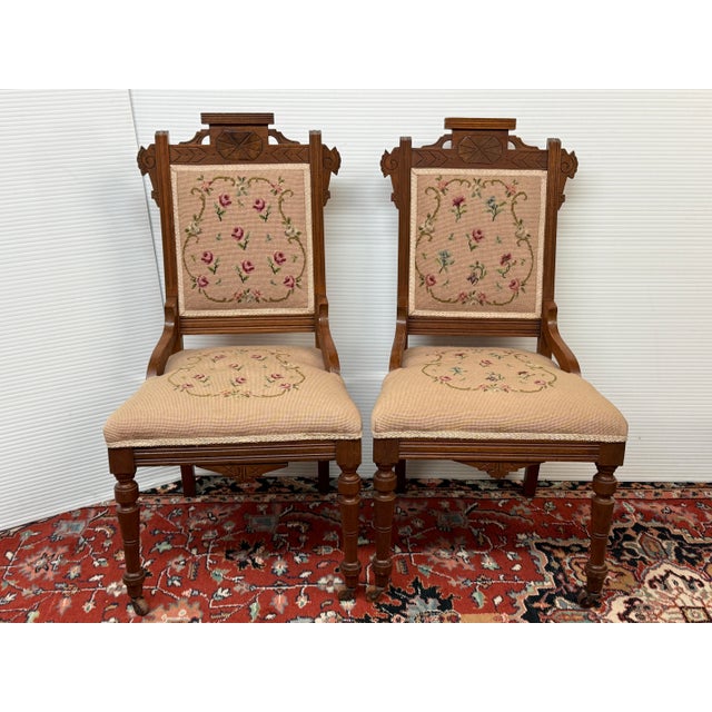 Design Plus Gallery presents a Pair of Needlepoint Parlor Side Chairs from the Late 19th Century Victorian Era. The chairs...