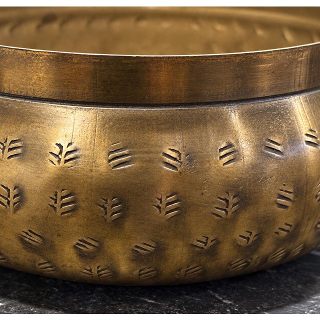 Beautiful vintage solid brass bowl featuring unique etched detailing throughout the exterior. Its warm golden tones and...