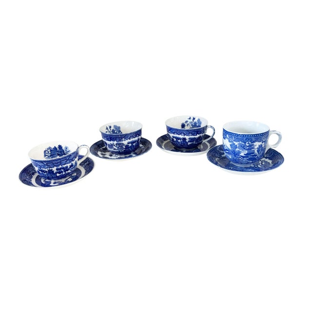 Vintage Blue and White porcelain set of four tea cups and matching plates featuring the iconic Willow Pattern design. This...