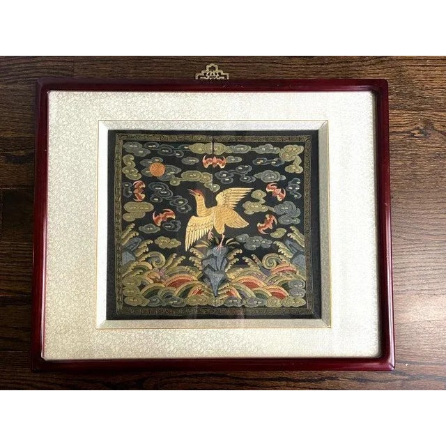 A finely embroidered silk civil rank badge panel framed in a wood frame circa late Qing dynasty 19th century. The square...