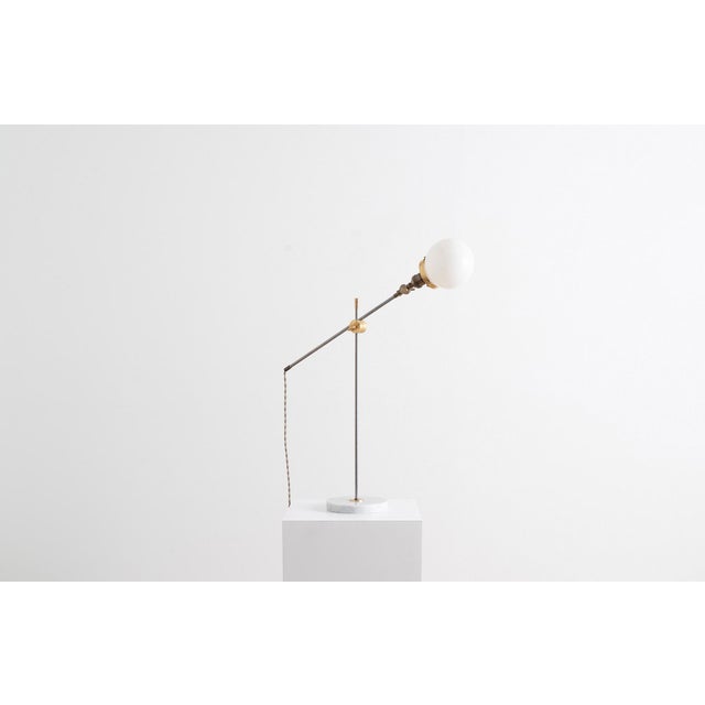 Available now and for immediate delivery. This slim lamp has a familiar presence that reminds us of the Art Deco style...