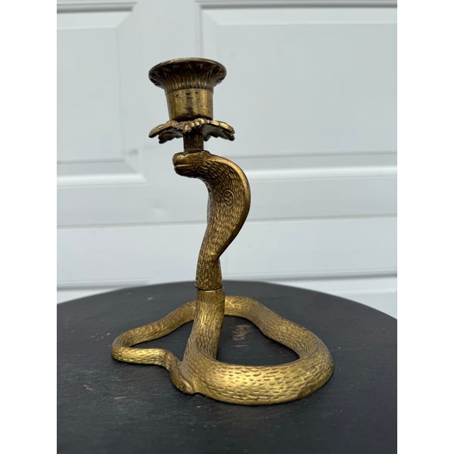 Antique late 20th century gilt iron cobra candlestick. Beautiful brass color over cast iron.