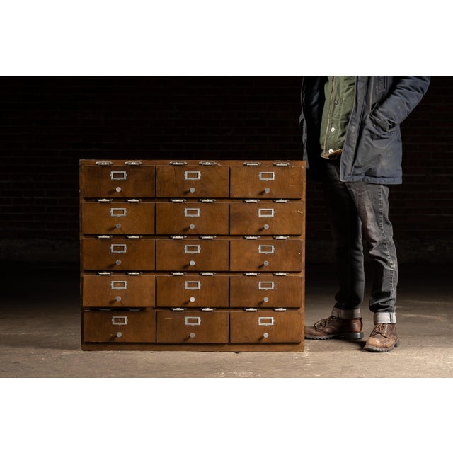 Heavy-duty oak storage cabinet constructed with an array of open-through cubbies, originally intended for shop, factory,...