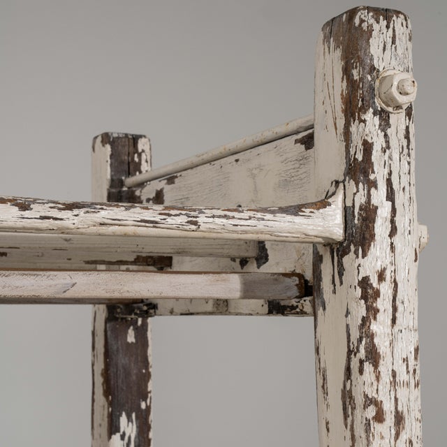 An authentic early 20th century French bakery rack featuring a beautifully aged white patina and original rolling wheels....