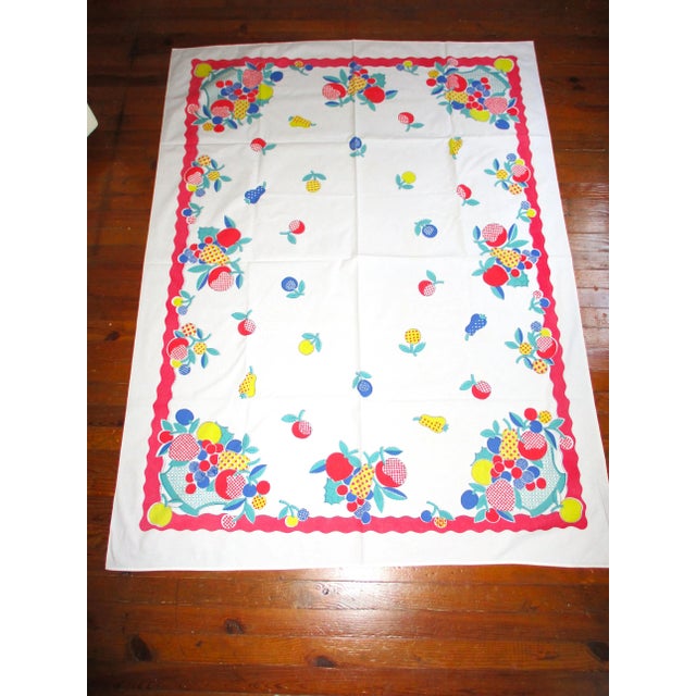 This is a Whimsical! Vintage 1950's Fruit in a Basket Design Red, Blue & Yellow Cotton Tablecloth 66" x 48.5" that is in...