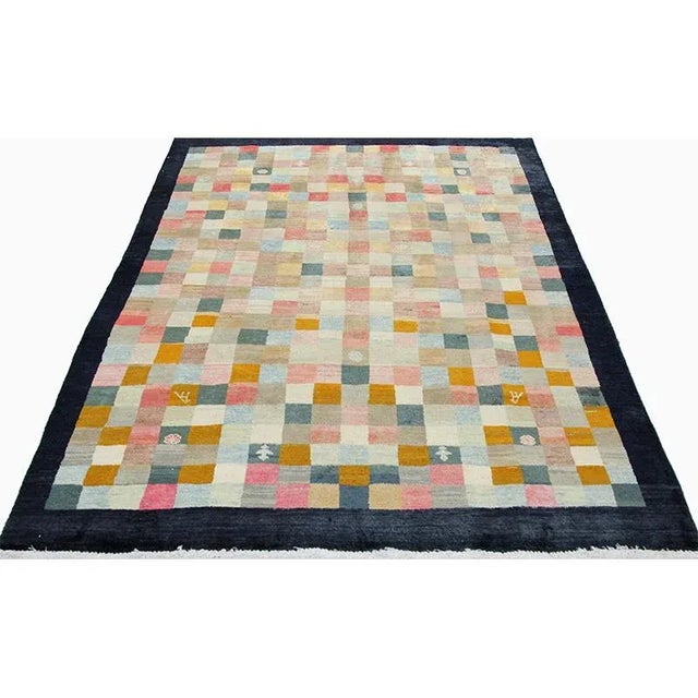 Old Traditional Handwoven Persian Shiraz Area Rug featuring a plaid design in multi-colored palette. Hand-woven with a...