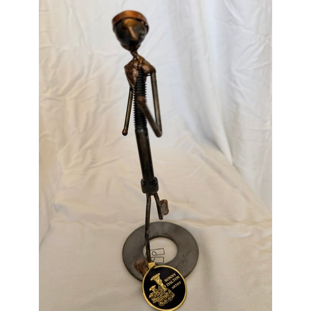 Whimsical vintage mixed-metal sculpture by American artist Sonny Dalton (1933–2011), depicting a runner in motion wearing...