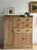 A Victorian stripped pine compactum in an asymmetric layout — a full-height wardrobe with an arched raised-panel door to...