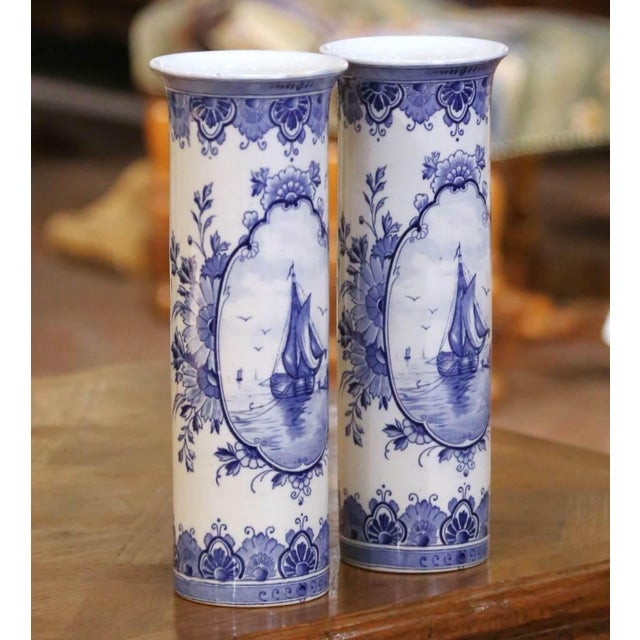 Decorate a mantel, console, or bookshelf with this elegant pair of antique Delft vases. Crafted in Holland circa 1920, the...