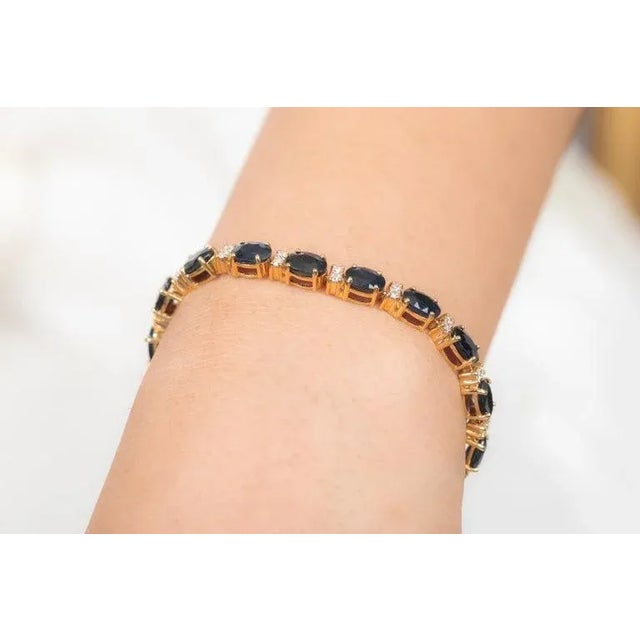 This is part of Chairish’s Fine Jewelry assortment. This Deep Blue Sapphire and Diamond Tennis Bracelet in 14K gold...