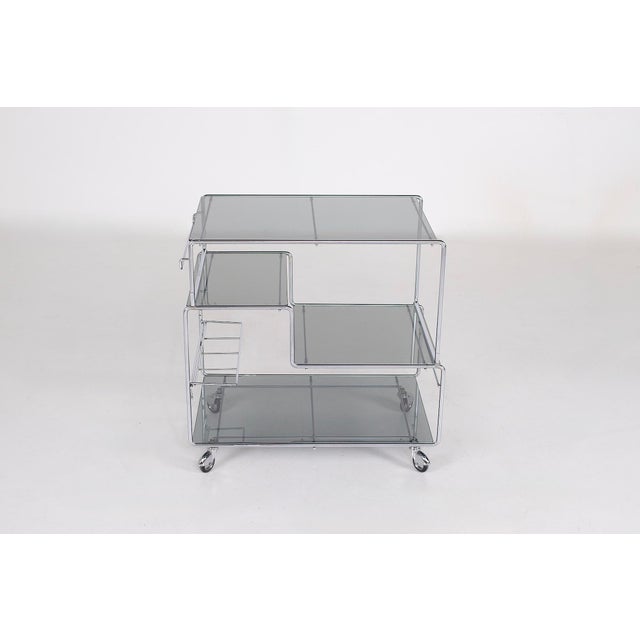 Max sauze, 1970: adjustable rolling trolley/serving cart in chromed steel and smoked glass. Small module: w 60 cm x d 40...
