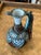 Enchanting Moroccan, pitcher crafted in terra-cotta, decorated in distinctive colors, glaze and adorned with jewelry like...