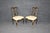 This fantastic pair of French Louis XV style side chairs embodies timeless sophistication with their richly carved...