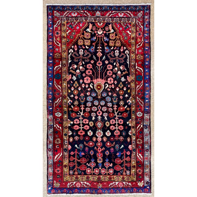Antique hand-knotted rug from the Nahavand region of western Iran, featuring a deep navy field with a prominent tree-of-...