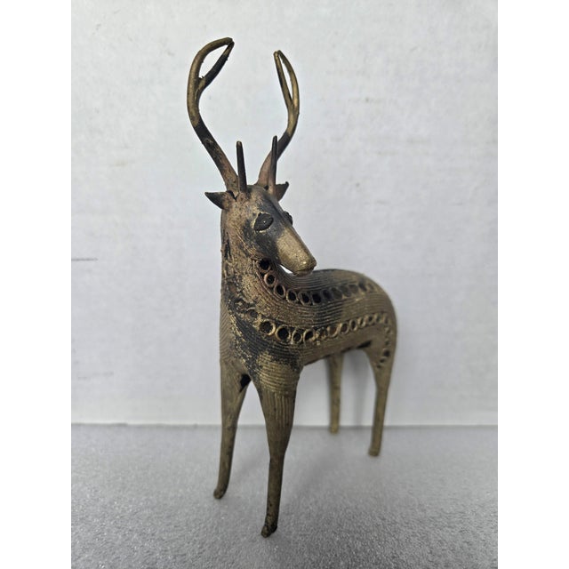 This elegant vintage sculpture of a deer showcases the beauty of the traditional metal casting technique called Dhokra...