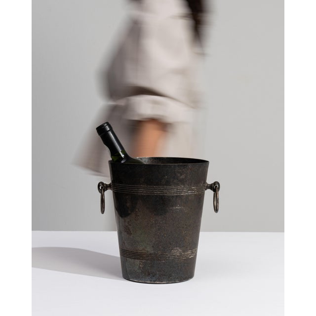This mid 20th century ice bucket from France is finished in chocolate, worked in silver. Its form follows honest, well-...