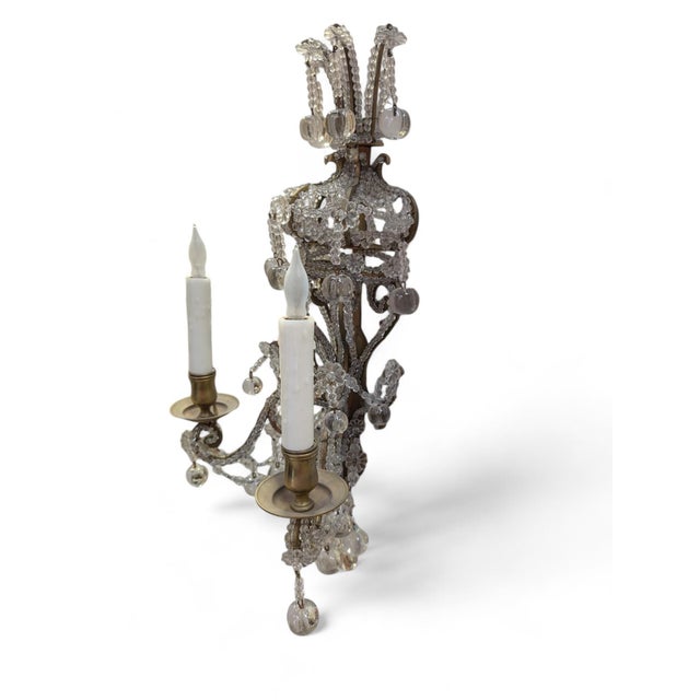 Louis XV style chandelier sconces decorated with glass beads, rosettes, smooth apple-drop crystals, and a smooth crystal...