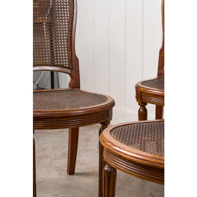 1930s Set of 6 | French Louis XVI Style Dining Chairs With Hand Caned Seats + Backs With Fluted Legs (C. 1920) For Sale - Image 5 of 10