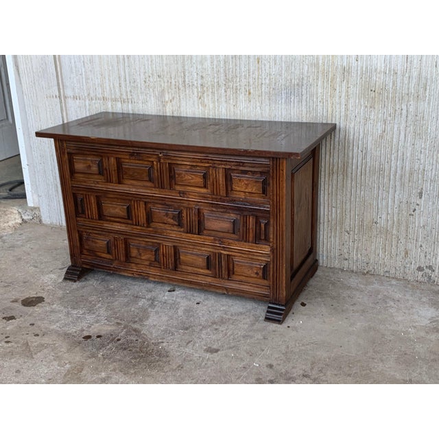 20th Spanish trunk with raised wooden panels and original iron hardware A Spanish carved wood blanket chest from the 20th...