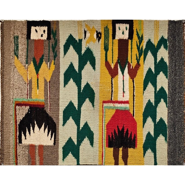 A vibrant and culturally rich vintage Navajo style Yei pictorial rug, handwoven during the third quarter of the 20th...