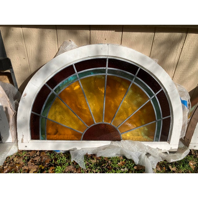 A stunning matched set of four original leaded stained-glass fanlight windows dating from the late 19th to early 20th...