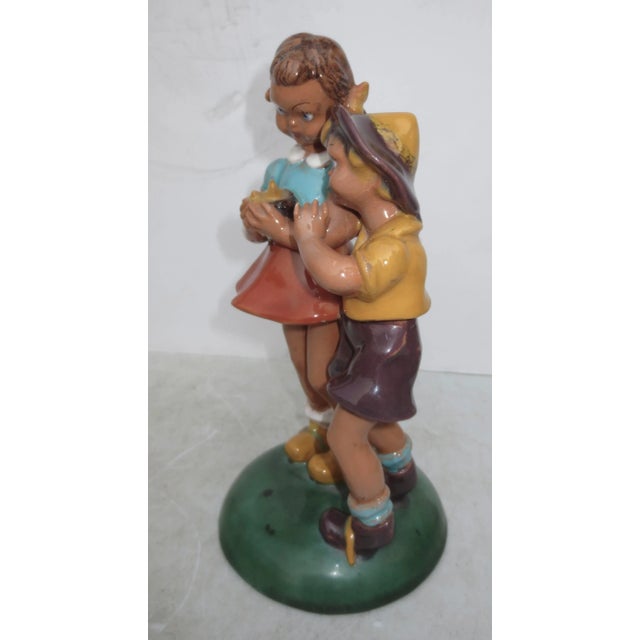 Two charming little kids in cartoon dresses pose in the moment of delight at the small nest they have, little birds....