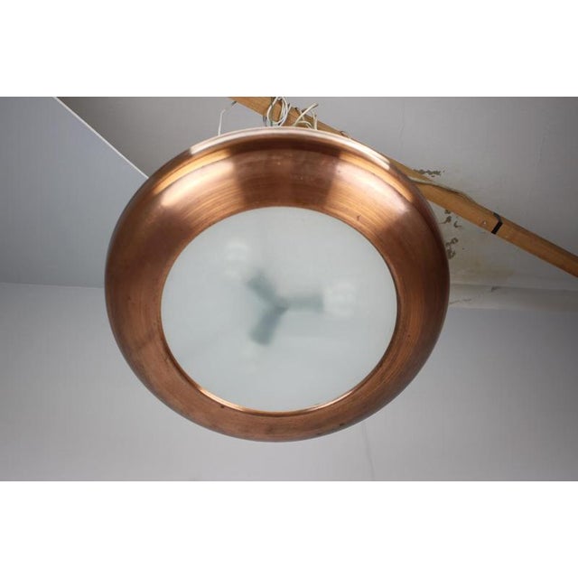 Exceptional art deco ufo hanging lamp produced in czechoslovakia during the 1930s. The lamp features a large copper shade...