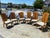 The American of Martinsville Campaign Light Wood & Cane Dining Chairs are a set of vintage dining chairs made in the...